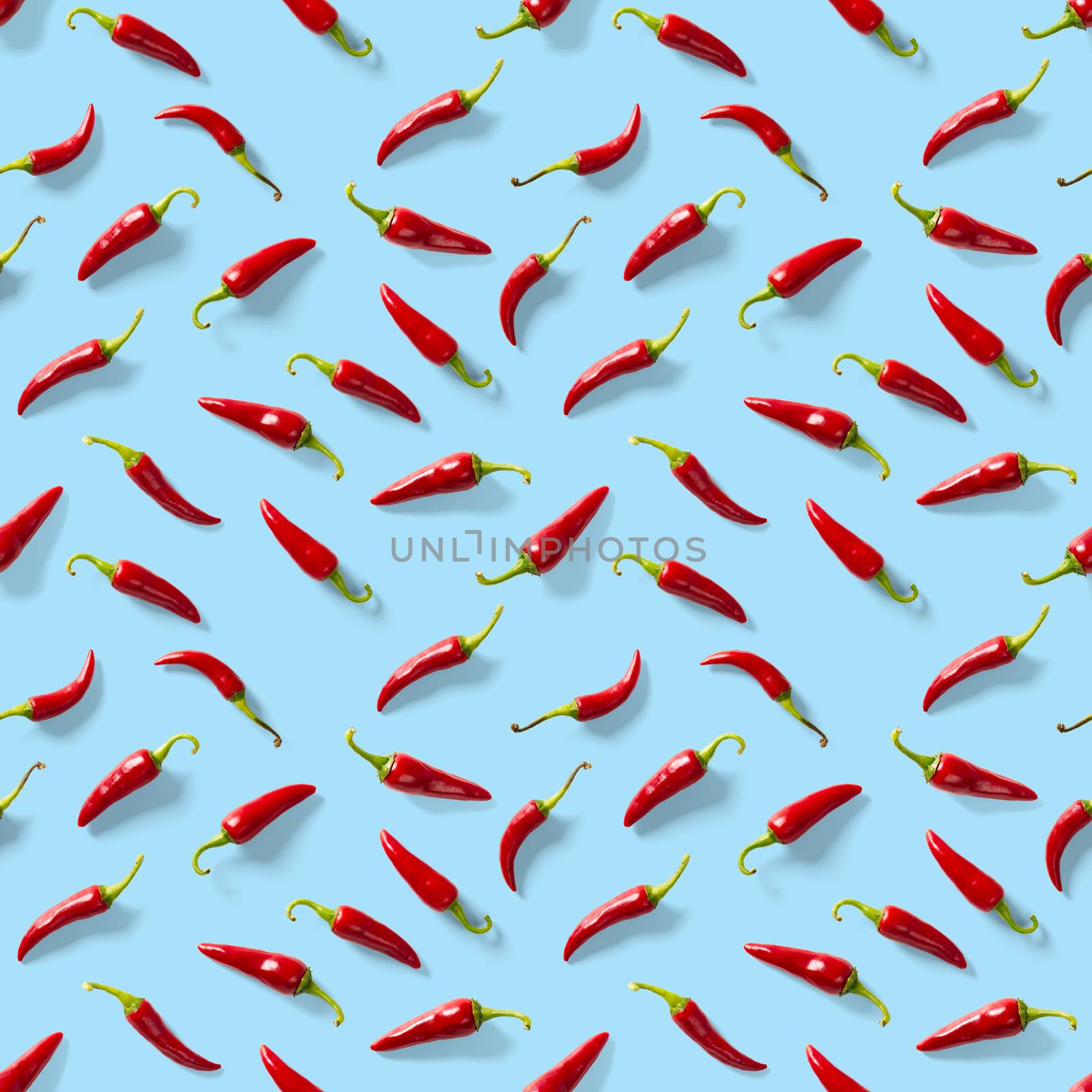 Red hot chilli seamless peppers pattern. Seamless pattern made of red chili or chilli on blue background. Minimal food pattern. Food background.