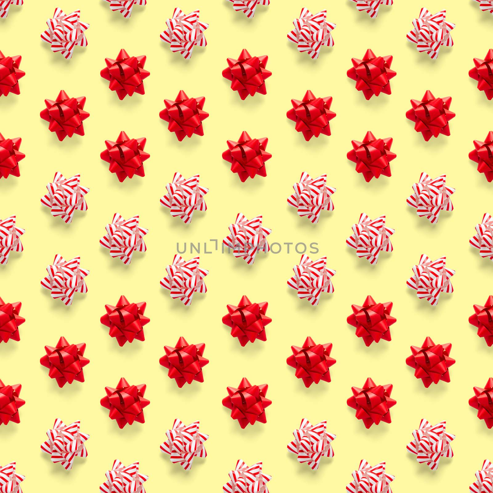 Seamless regular creative Christmas pattern with New Year decorations on yellow background. xmas Modern Seamless pattern made from christmas decorations. Photo quality pattern for fabric, prints, wallpapers, banners or creative design works.