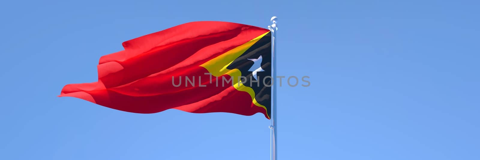 3D rendering of the national flag of East Timor in the wind against a blue sky