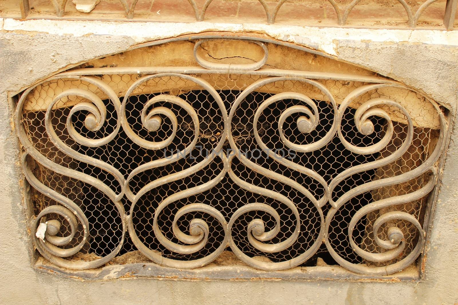 Old rusty metal grate in old building in Spain