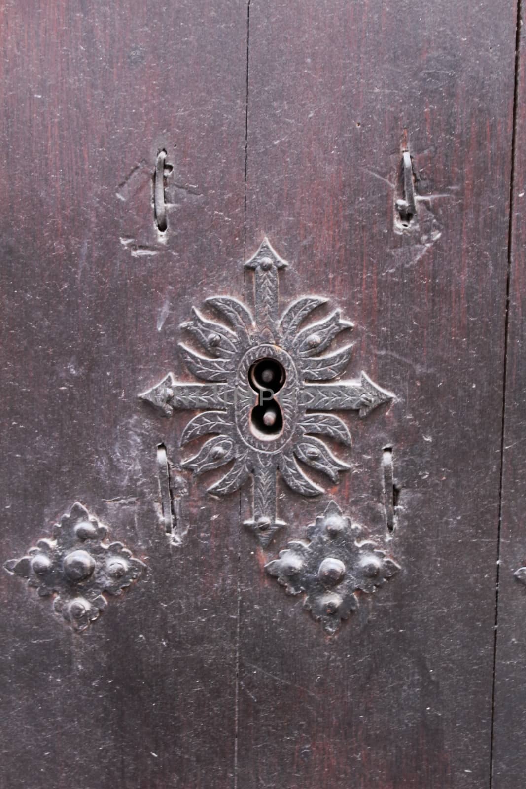 Old wooden door with wrought iron details in Villanueva de Los Infantes village, Spain