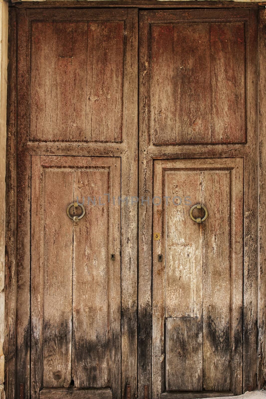 Old wooden door with wrought iron details in Villanueva de Los Infantes village, Spain