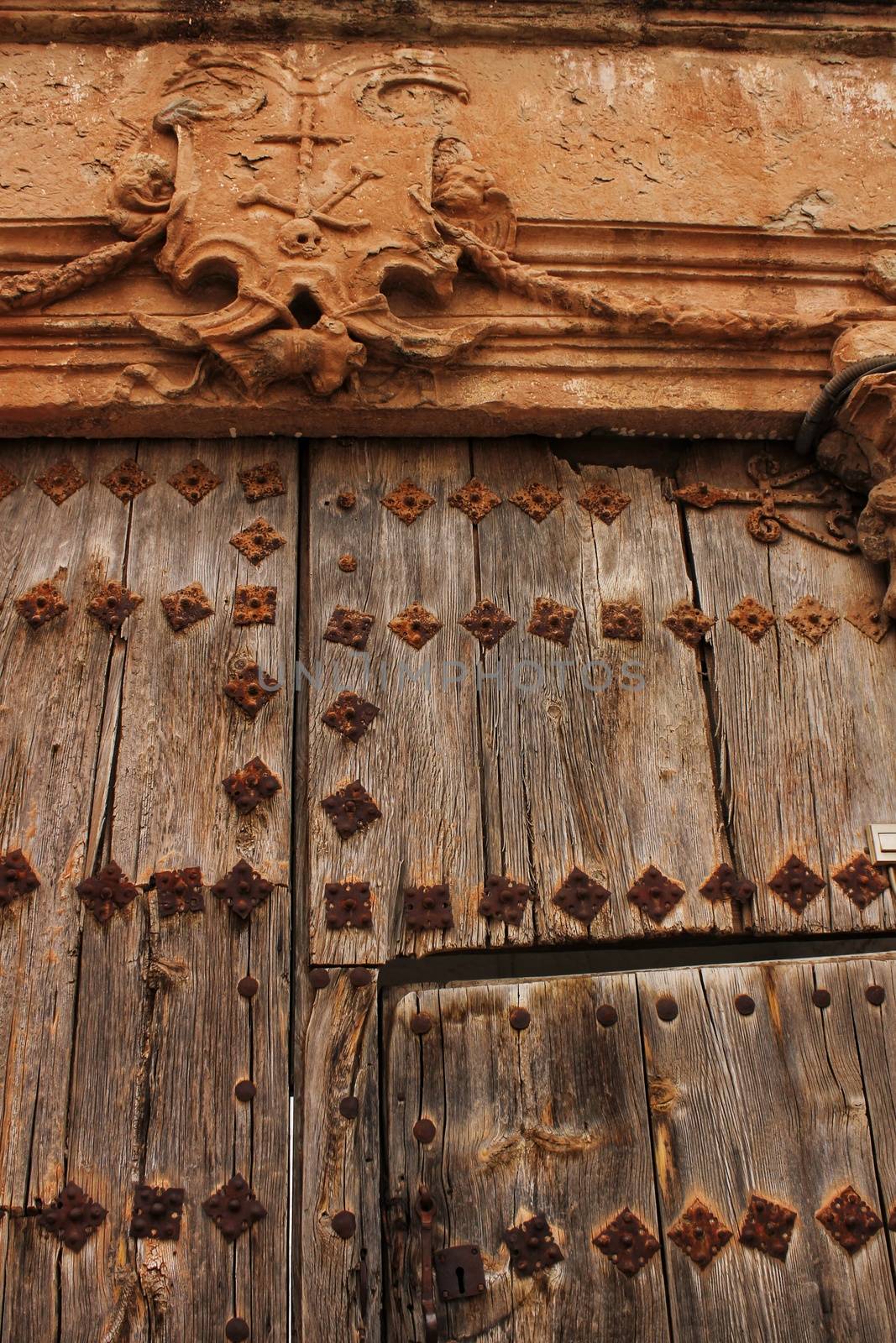 Old wooden door and coat of arms of the Holy Inquisition by soniabonet