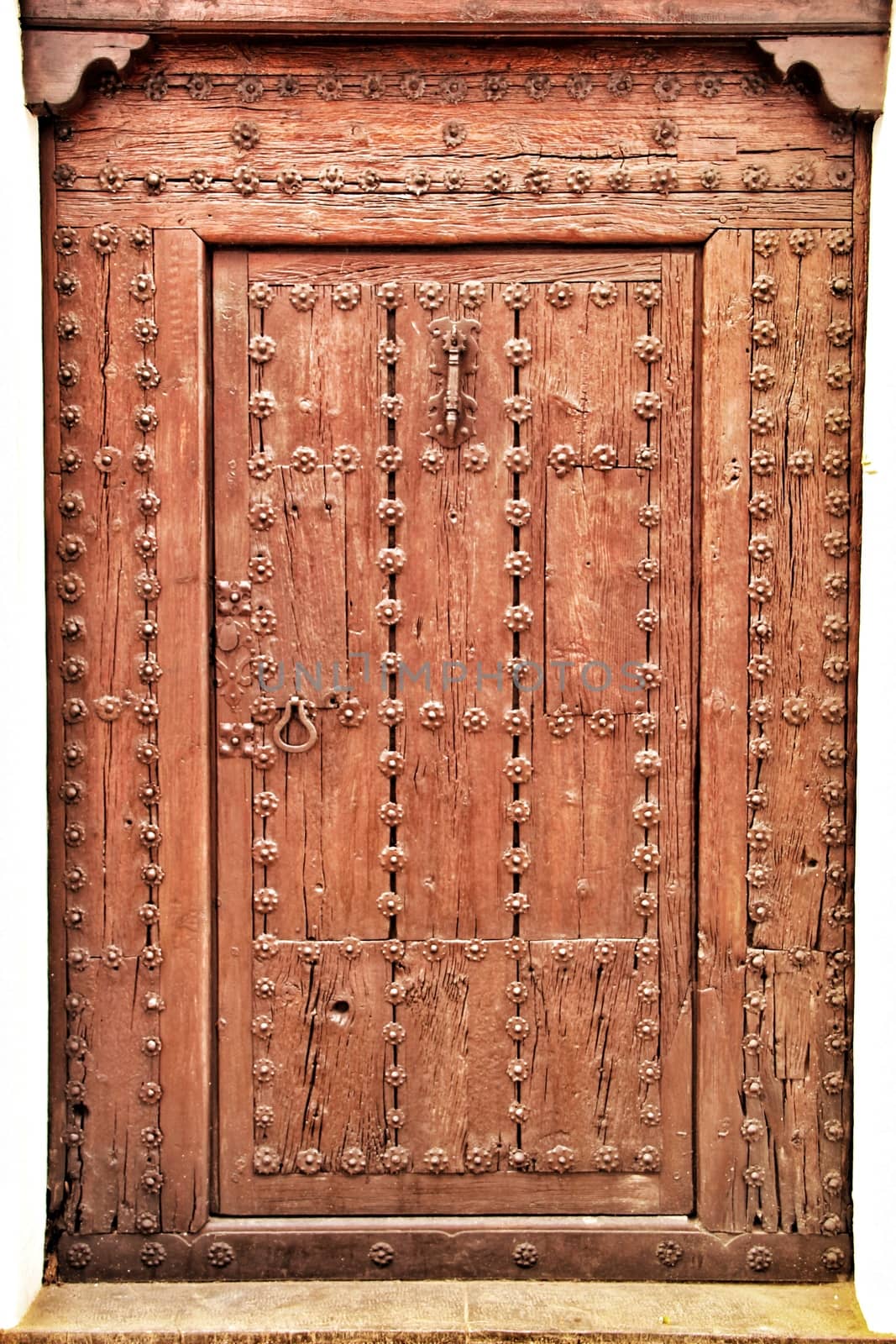 Old and colorful wooden door with iron details in Altea, Alicante, Spain