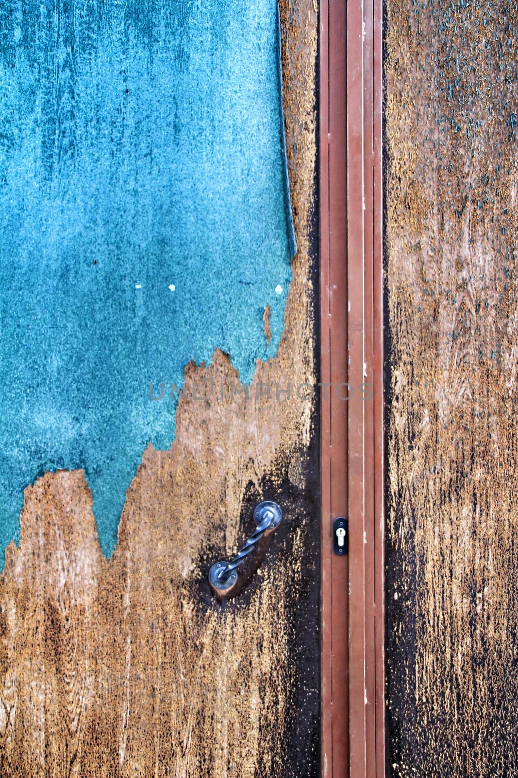 Colorful texture of old paint on rusty metal door by soniabonet