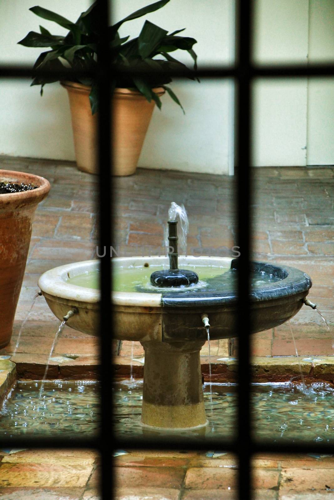 Decorative fountain in an andalusian patio in a house of Cordoba, Spain