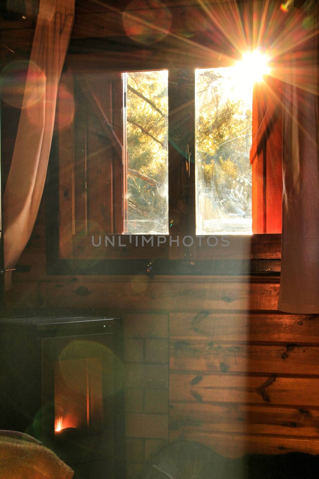 Morning sunlight entering through the window in log cabin