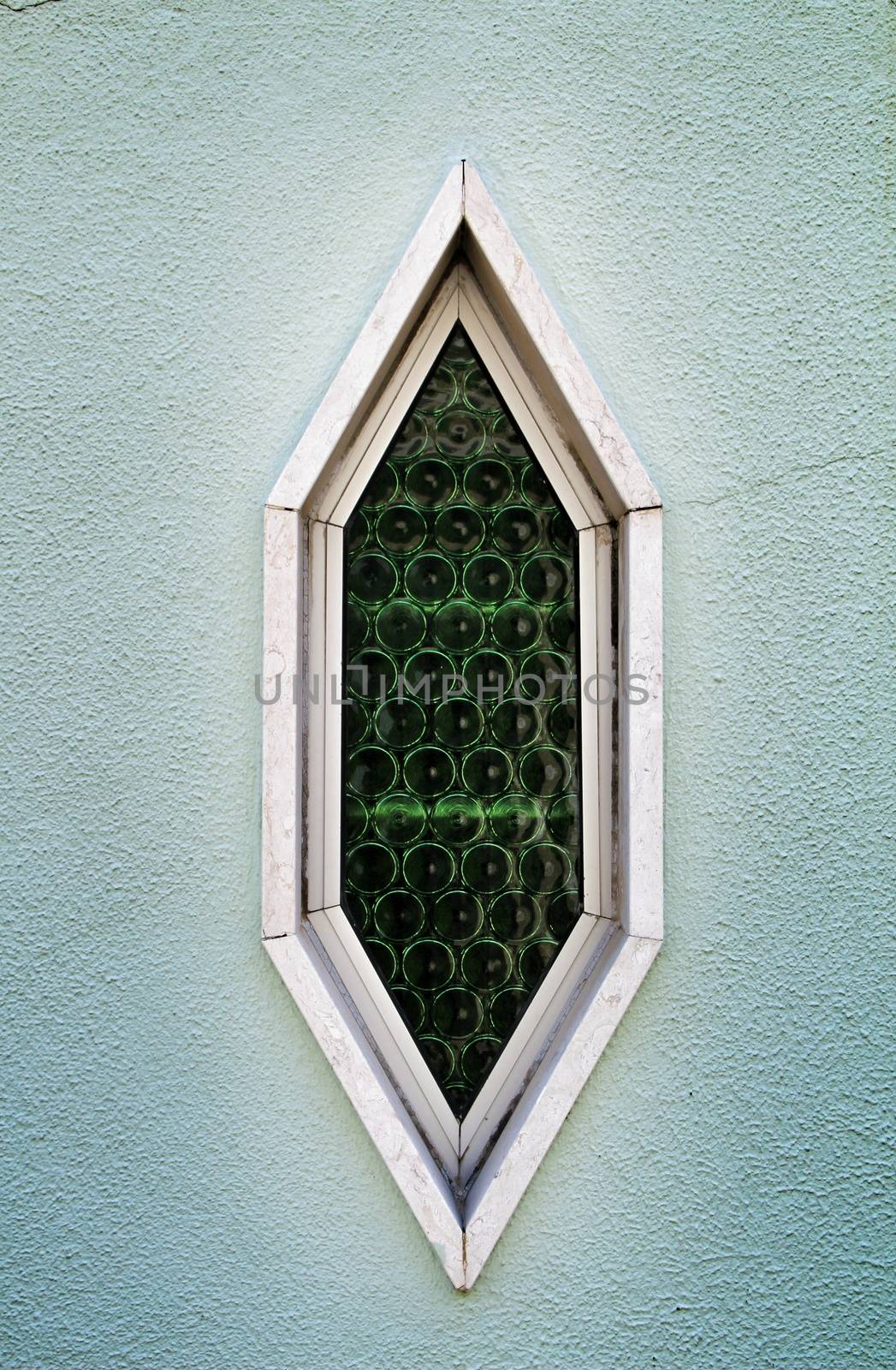 Beautiful Old and colorful wooden door with iron details and diamond shaped window in Lisbon, Portugal