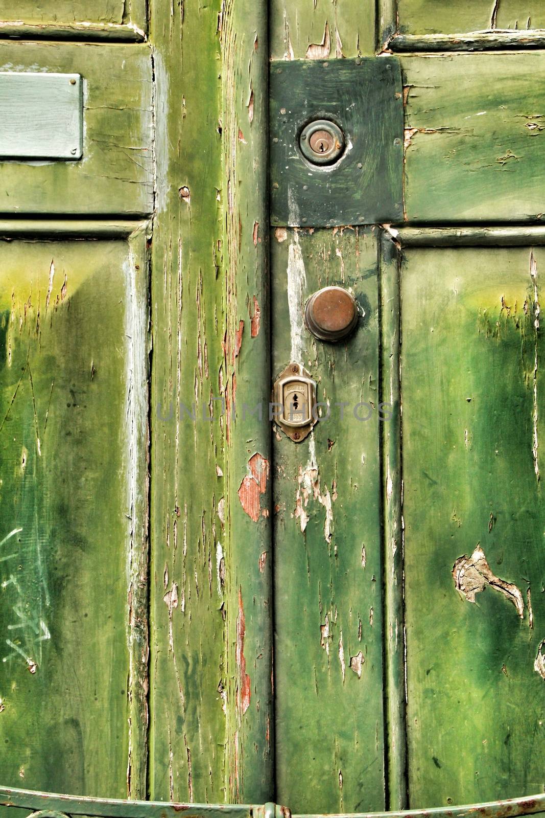 Old wooden green door with wrought iron details by soniabonet