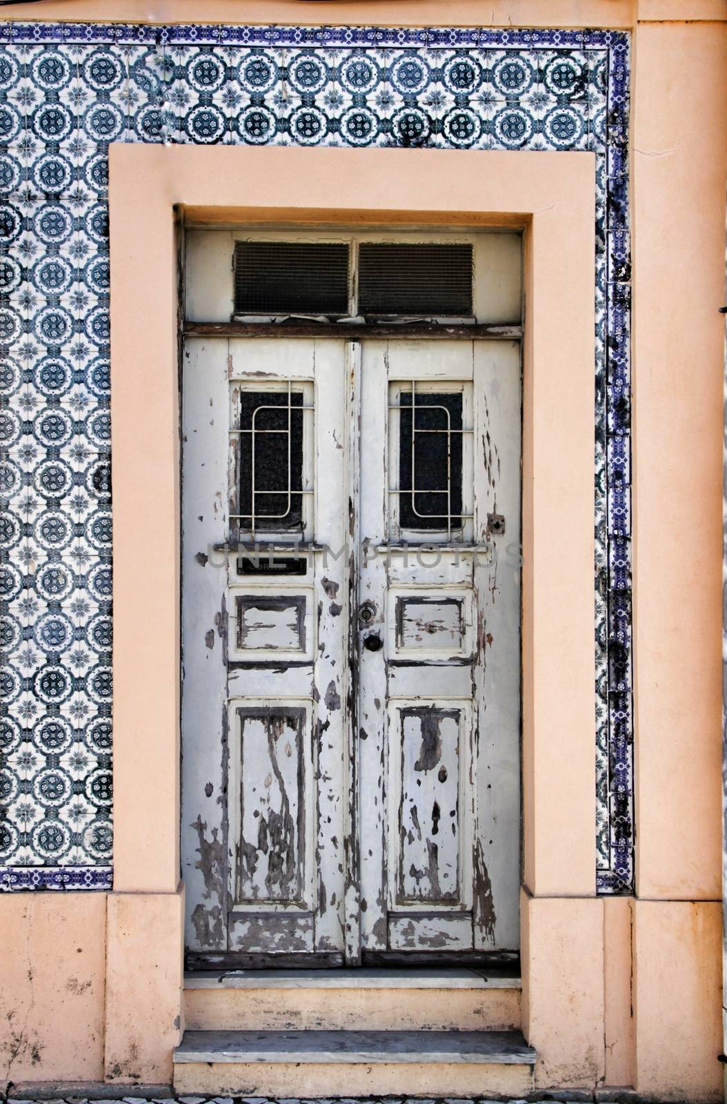 Old wooden white door with wrought iron fence in Porto, Portugal