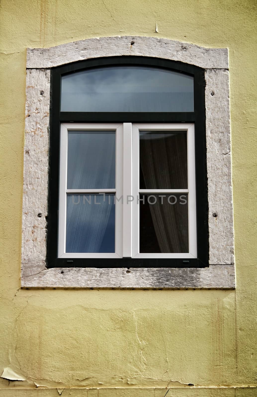 Old colorful and bright typical facade in Lisbon with beautiful vintage wooden window