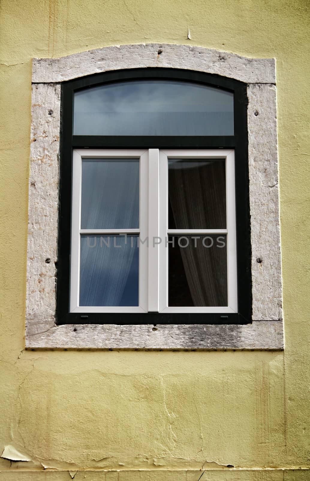 Old colorful and bright typical facade in Lisbon with beautiful vintage wooden window