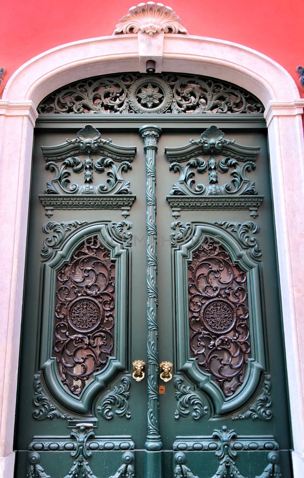 Old and colorful carved wood door with iron details in Lisbon, Portugal