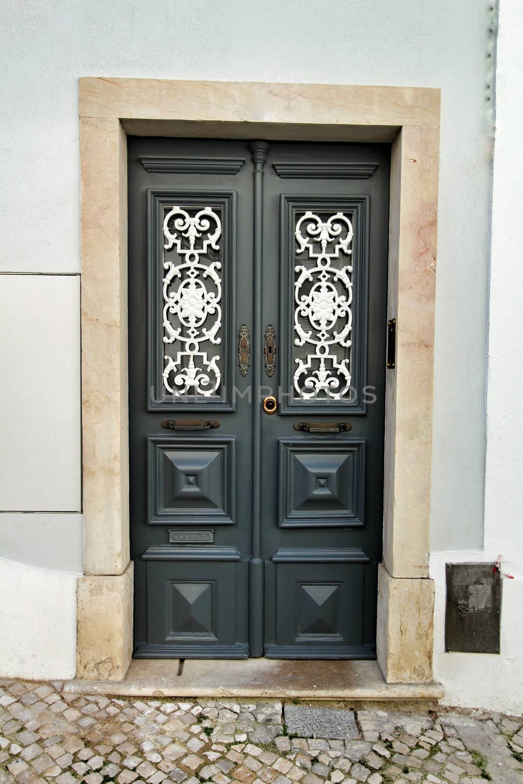 Old and colorful wooden door with iron details by soniabonet