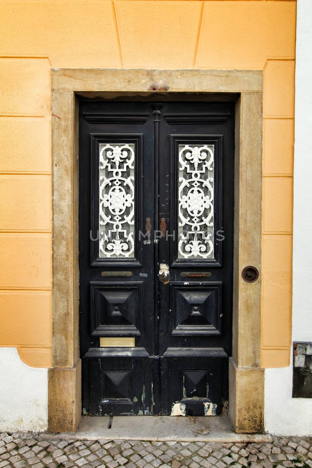 Old and colorful wooden door with iron details in Lisbon, Portugal