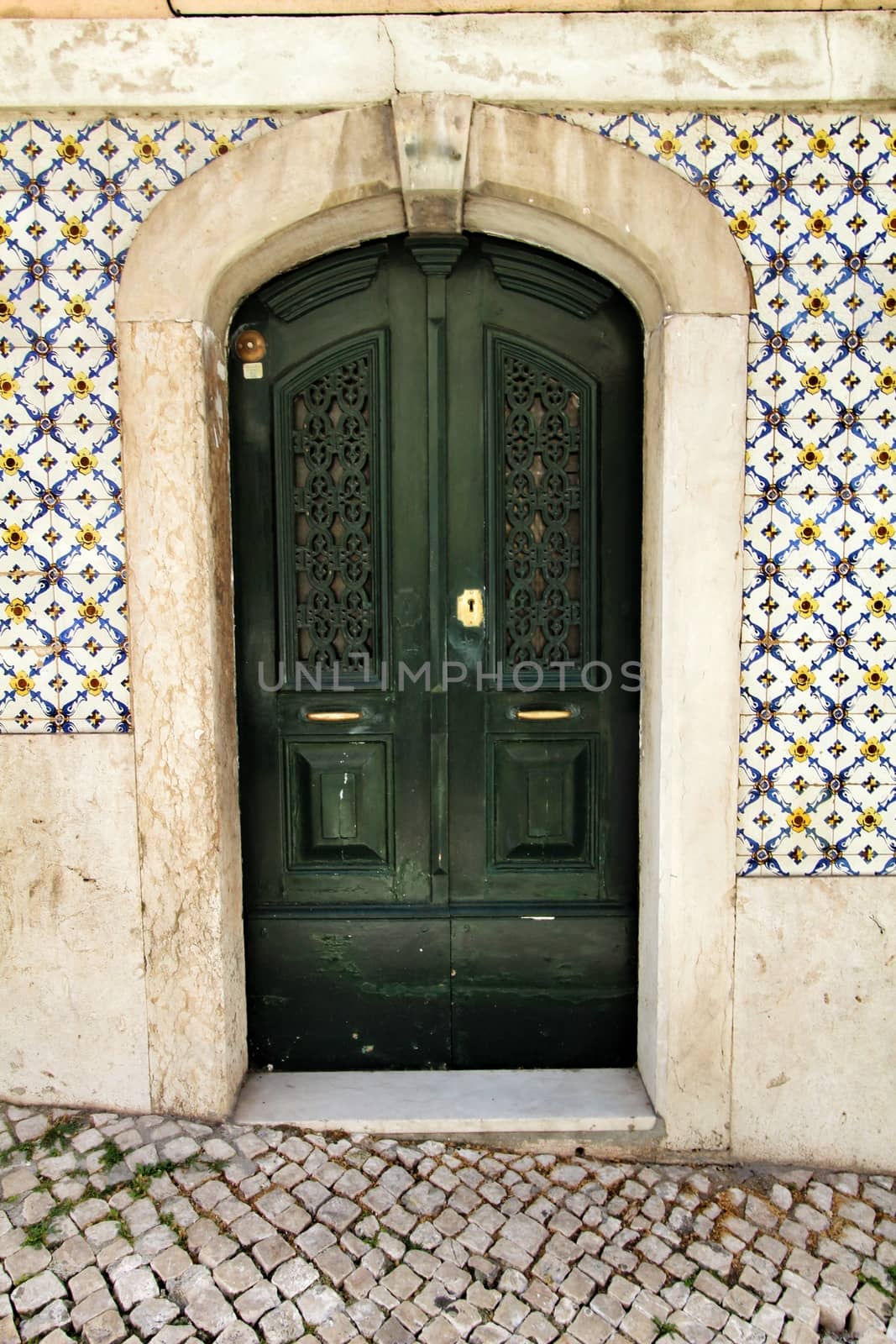 Old and colorful wooden door with iron details in Lisbon, Portugal