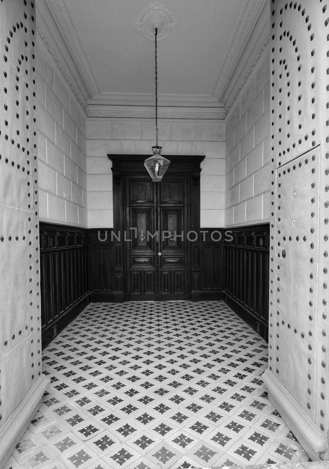 Entrance of majestic modernist style house in Alicante. Beautiful door with forged metal details and typical tiled floor