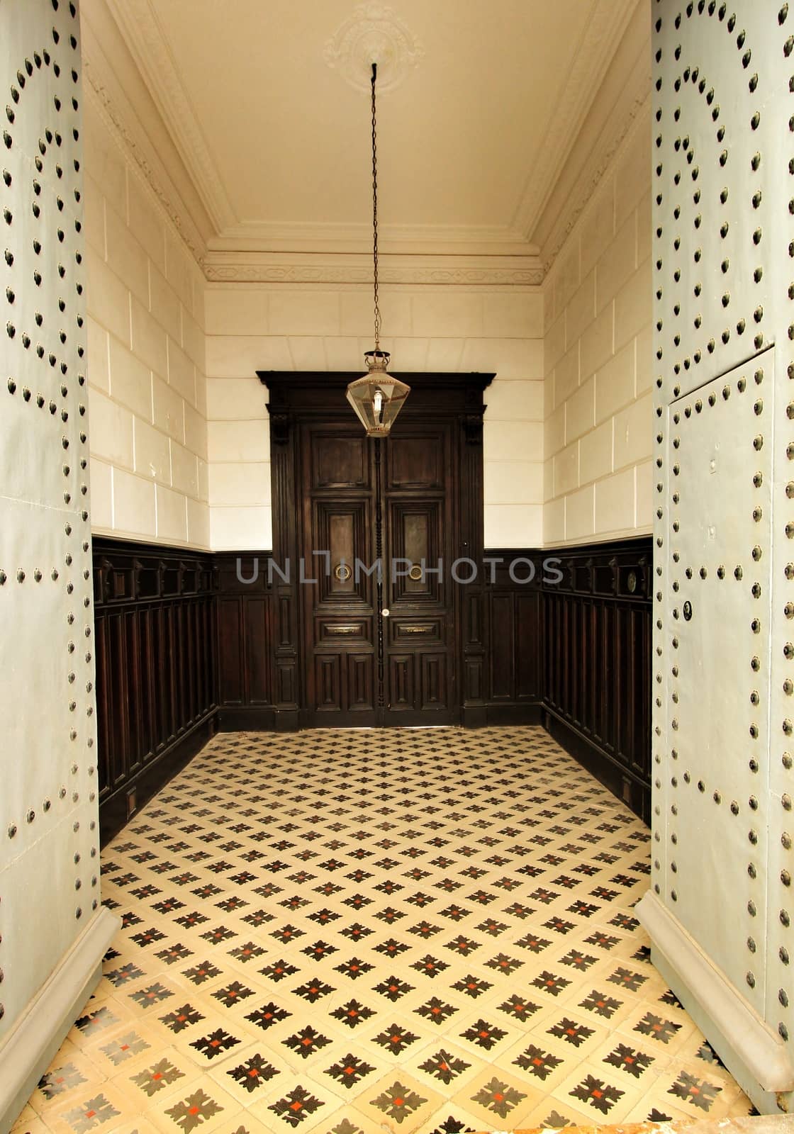 Entrance of majestic modernist style house in Alicante. Beautiful door with forged metal details and typical tiled floor