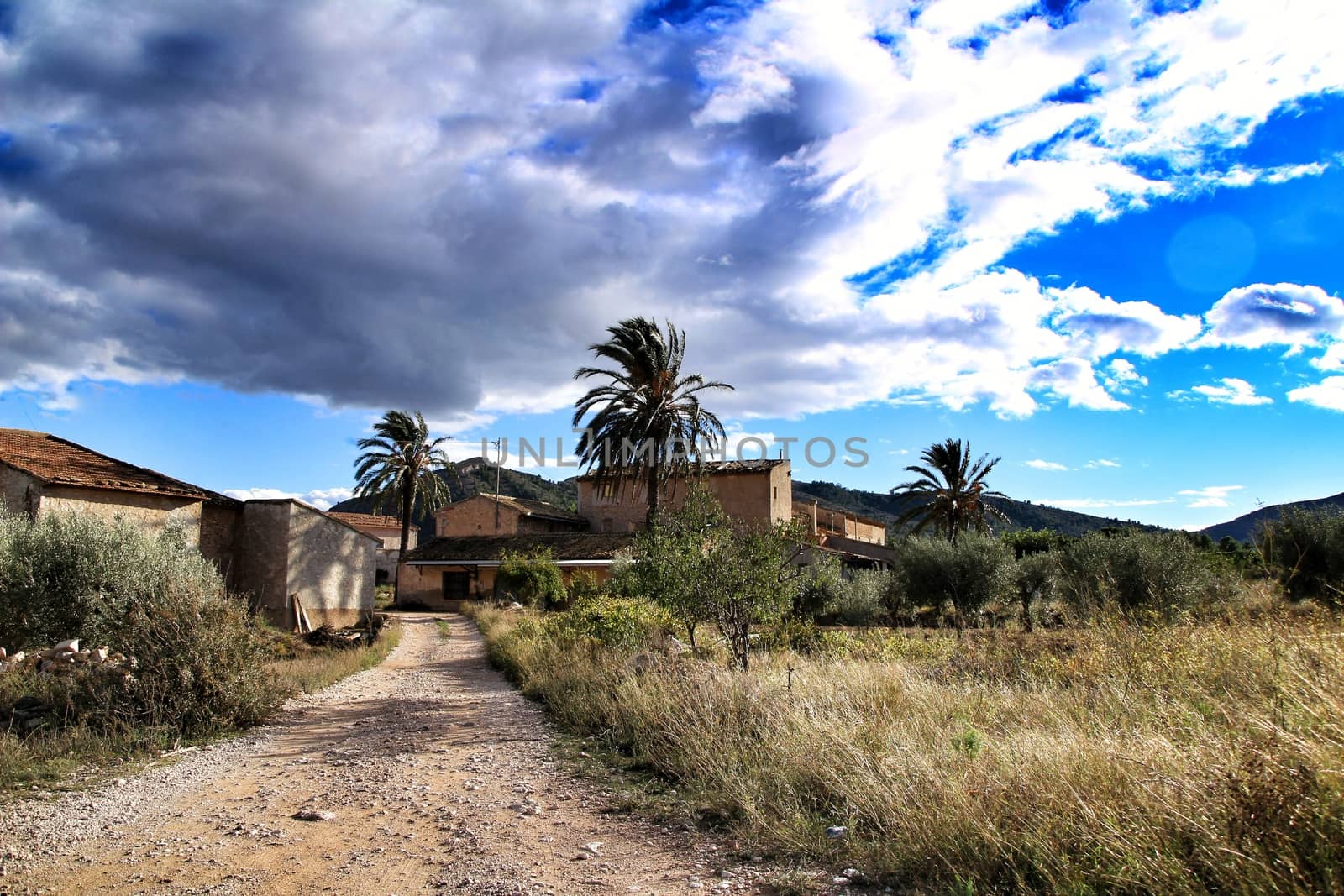 Beautiful country house in Hondon de las nieves, Alicante province, Spain, under cloudy sky and surrounded by vegetation