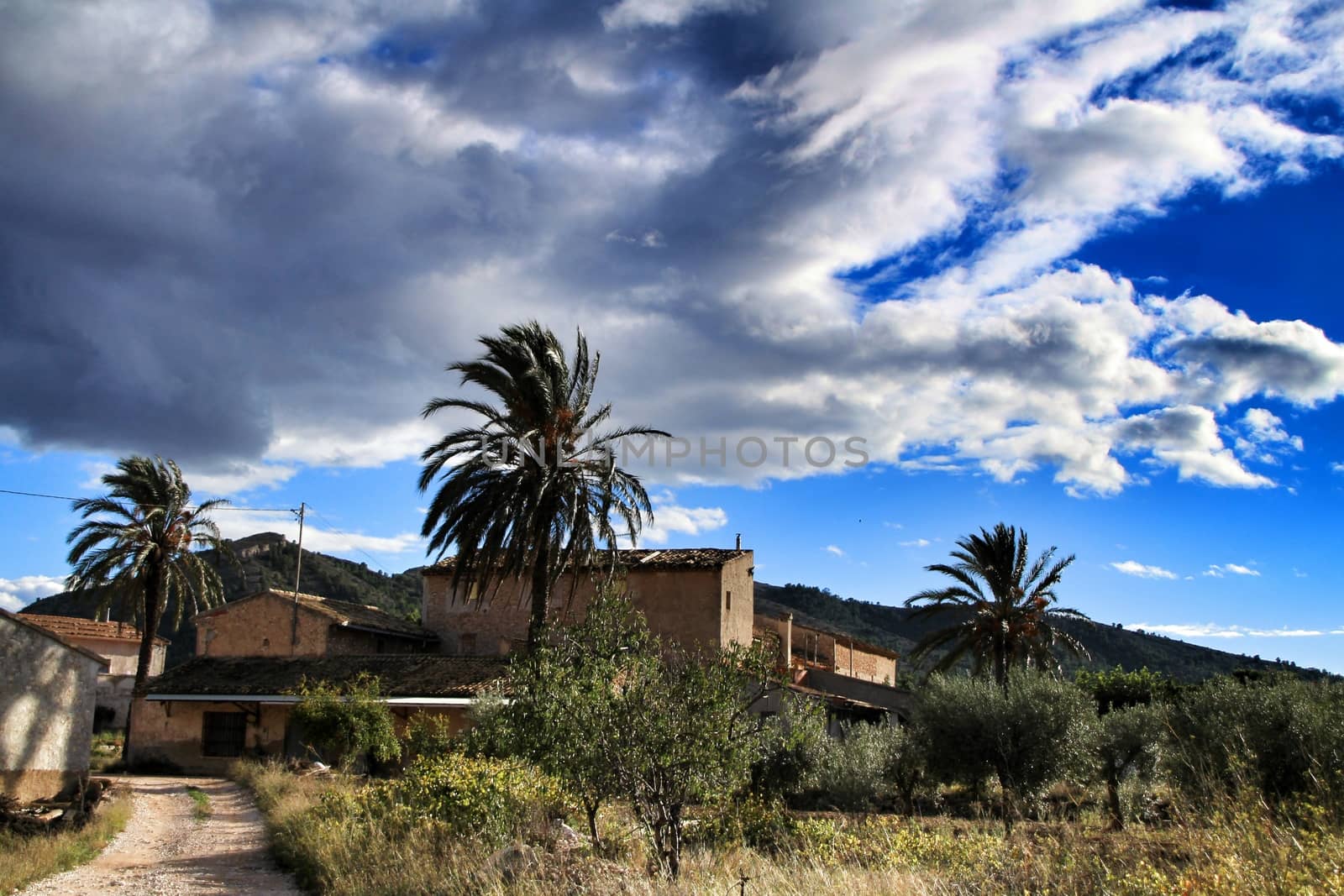 Beautiful country house in Hondon de las nieves, Alicante province, Spain, under cloudy sky and surrounded by vegetation