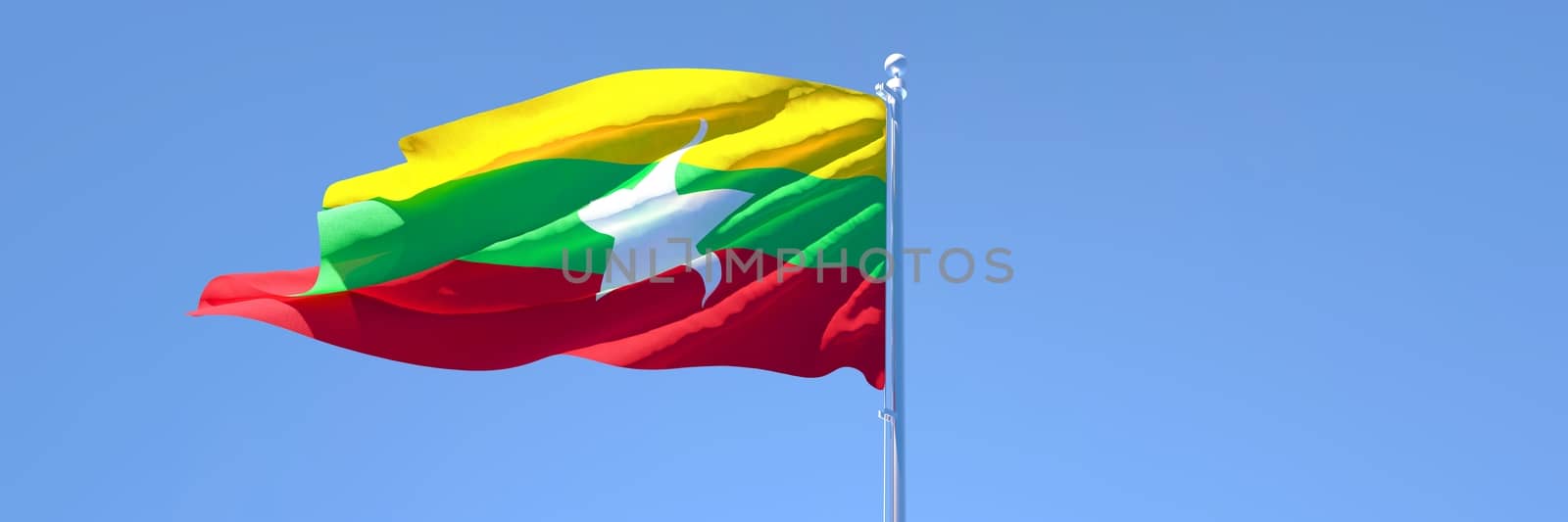 3D rendering of the national flag of Myanmar waving in the wind against a blue sky