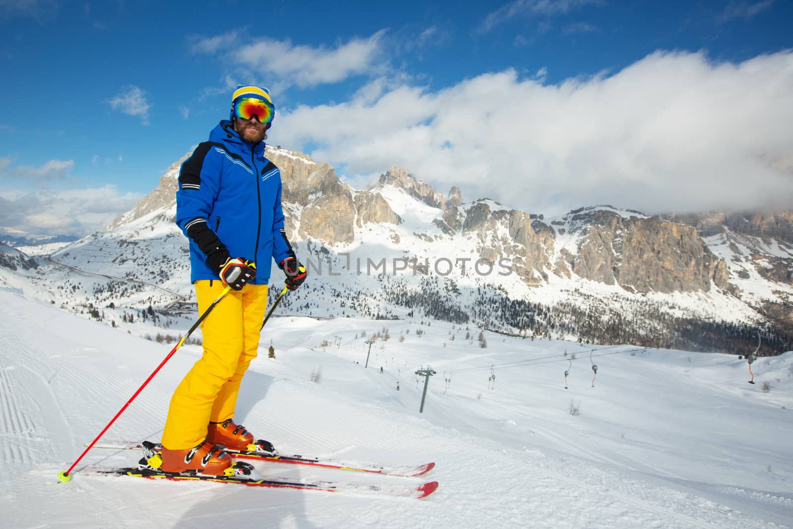 Alpine skier stand on slope in winter mountains Dolomites Italy in beautiful alps Cortina d'Ampezzo Col Gallina mountain peaks famous landscape skiing resort area