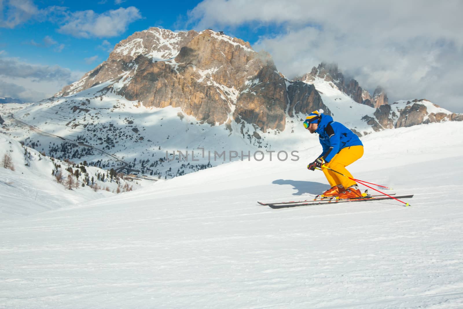 Alpine skier on slope at Cortina by destillat