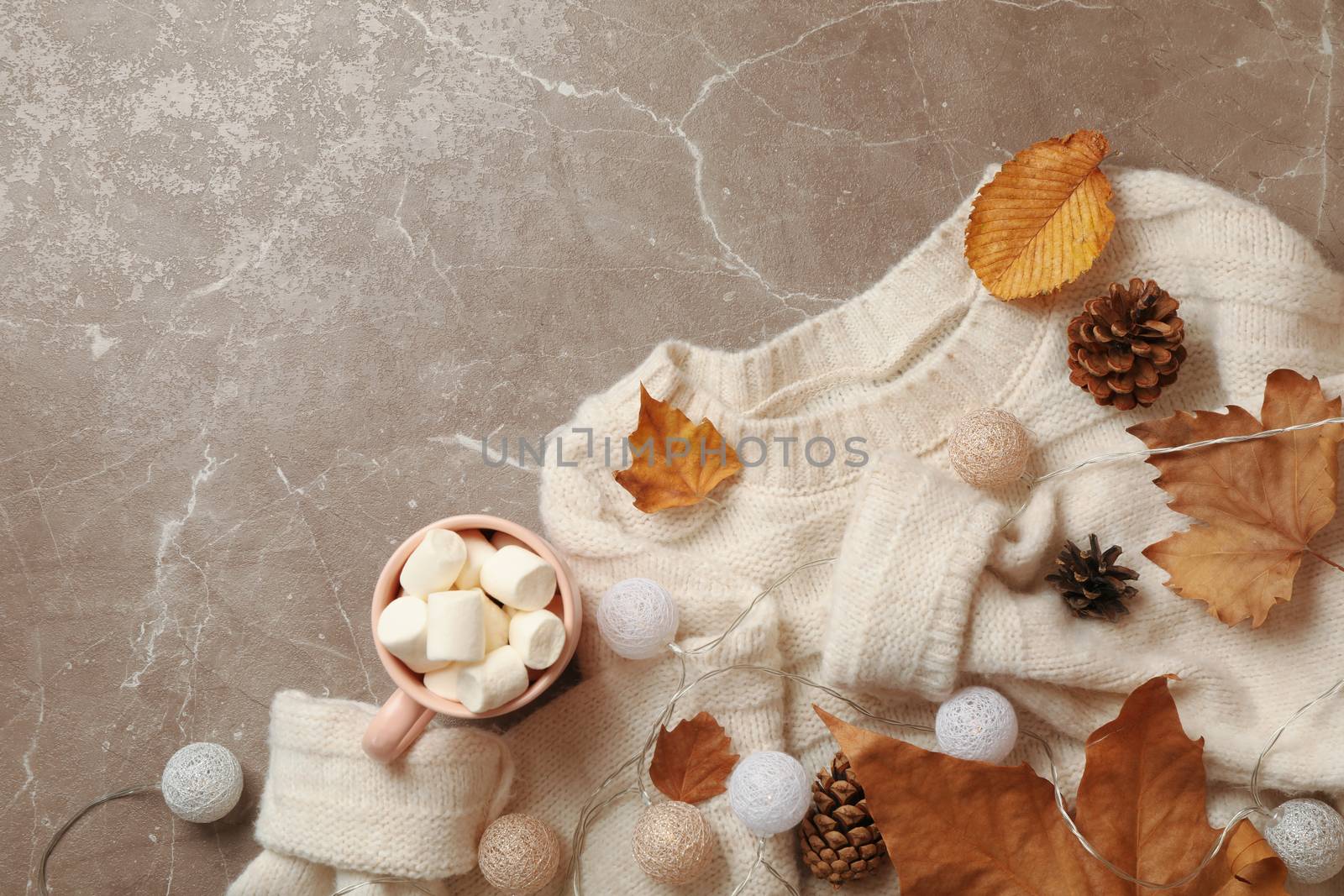 Autumn concept with sweater and coffee on gray background by AtlasCompany