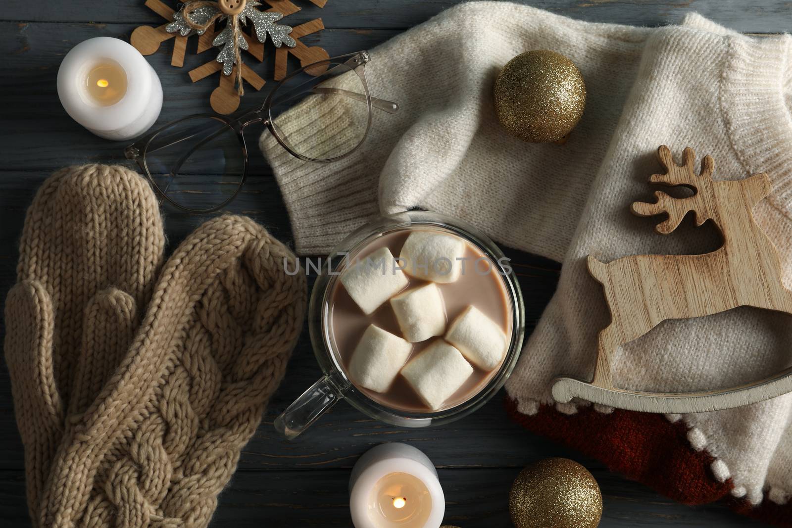 Winter concept with coffee with marshmallow, sweater and candles by AtlasCompany