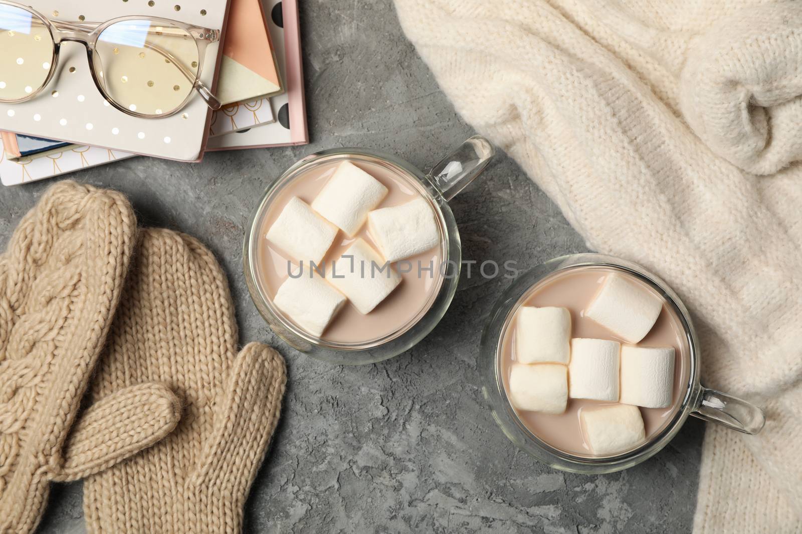 Winter concept with cups of coffee with marshmallow on gray background