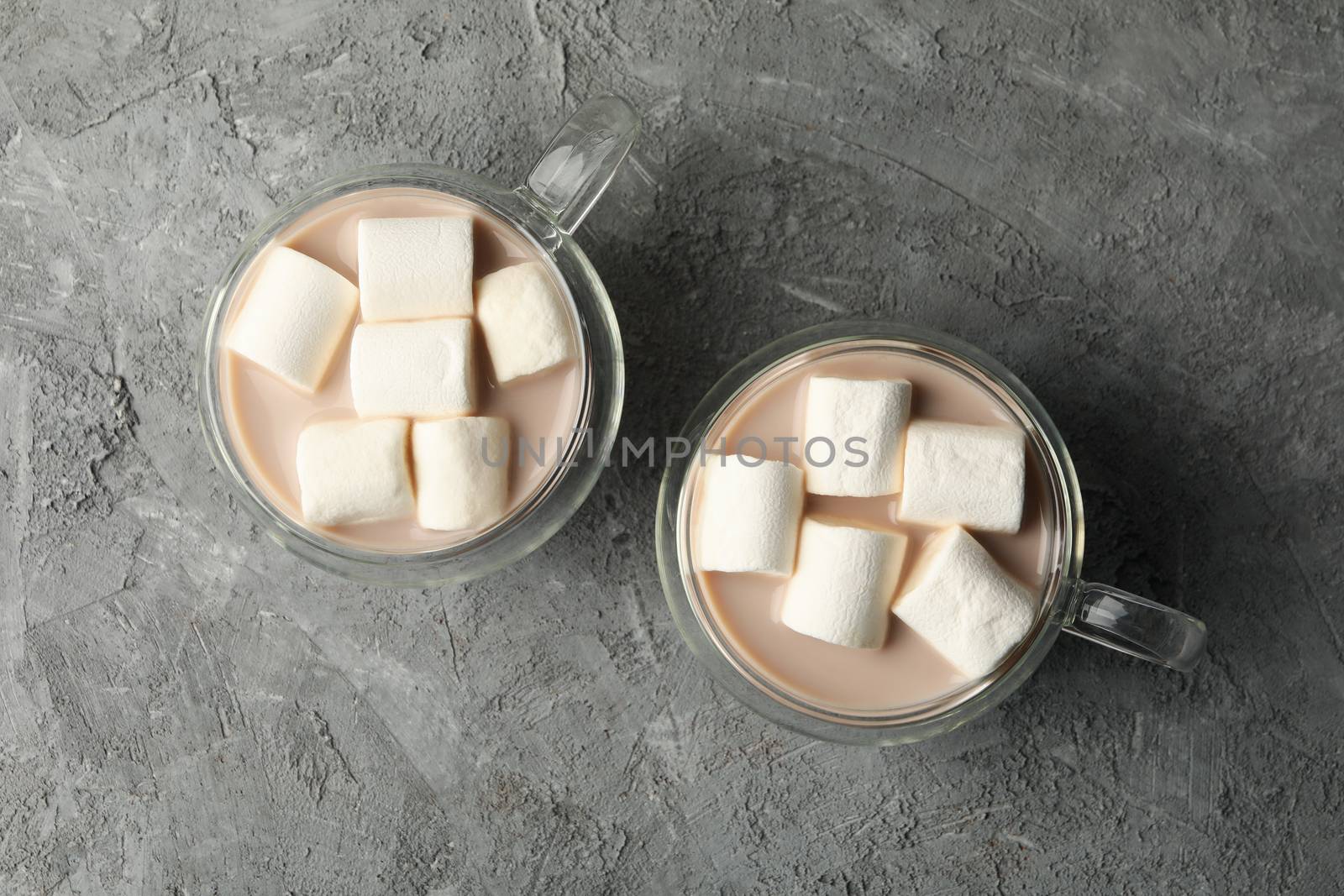 Cups of coffee with marshmallows on gray background by AtlasCompany