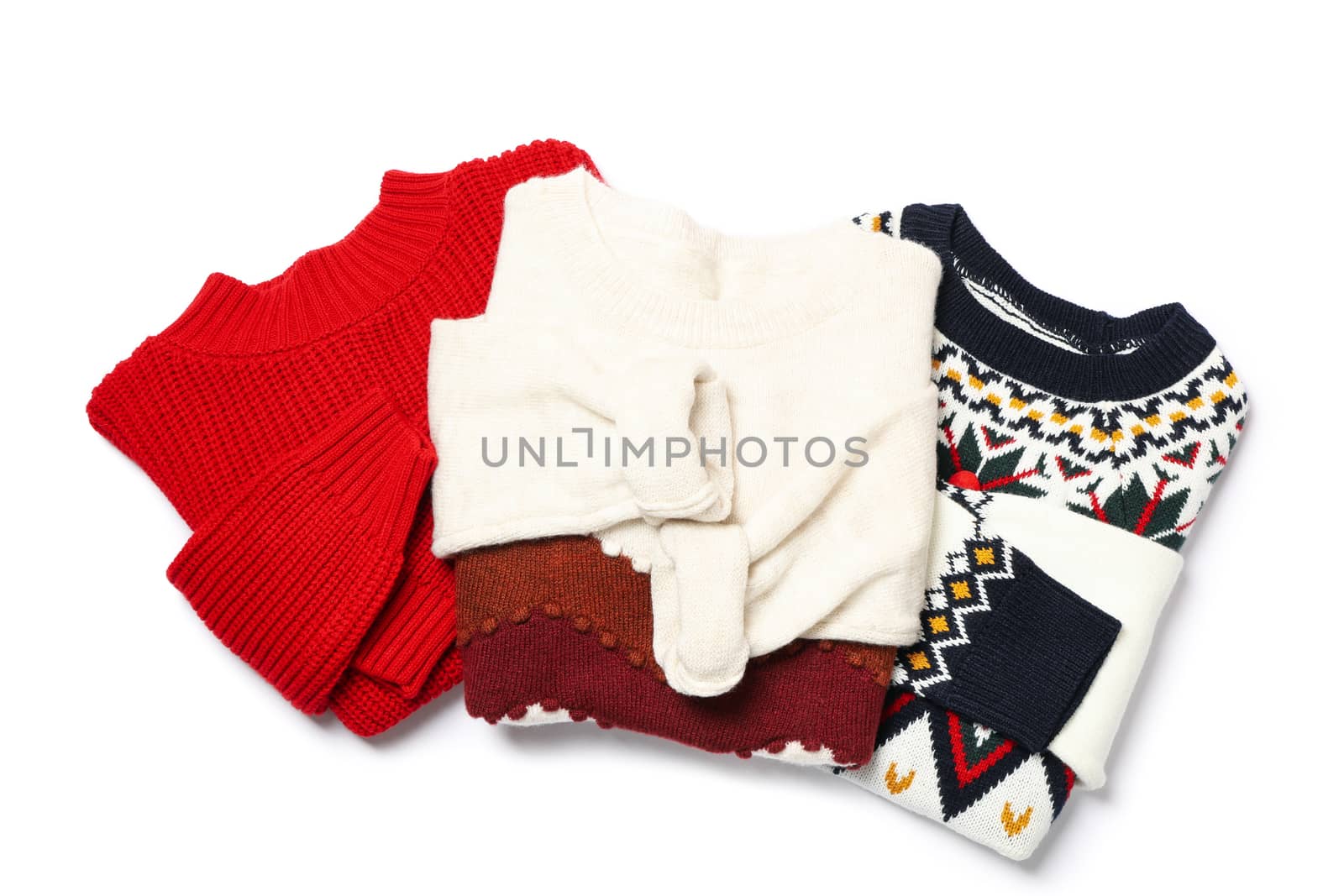 Knitted sweaters isolated on white background, top view