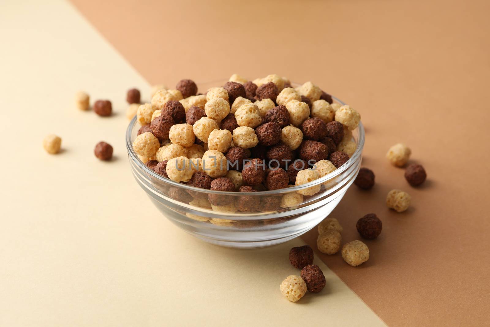 Bowl with corn balls on two tone background