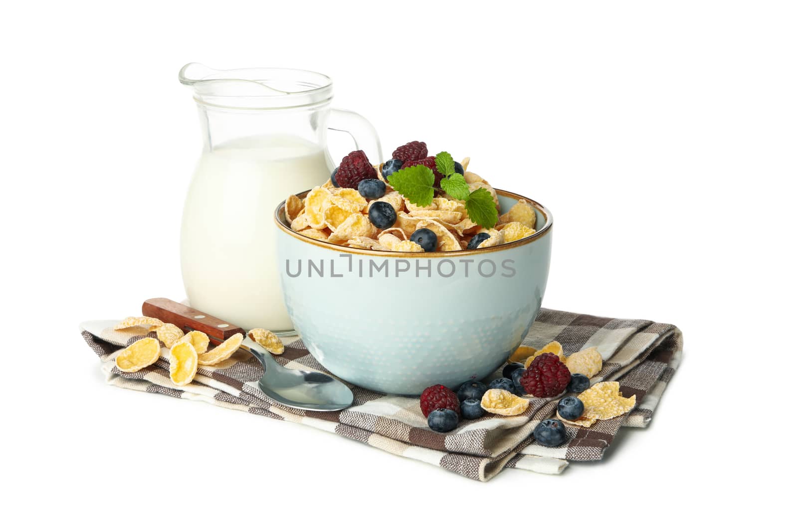 Napkin with milk, muesli and spoon isolated on white background