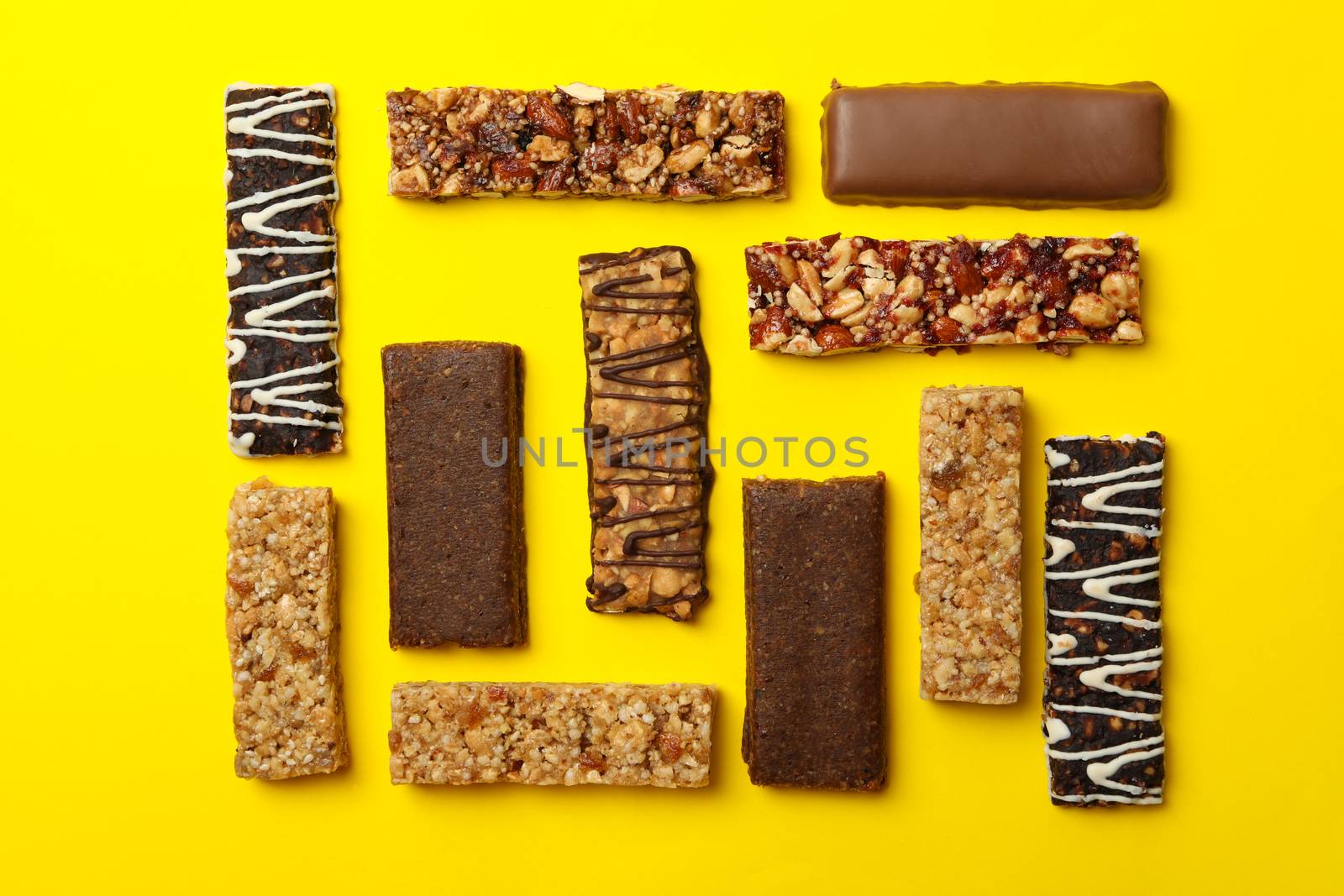 Flat lay with tasty granola bars yellow background, top view