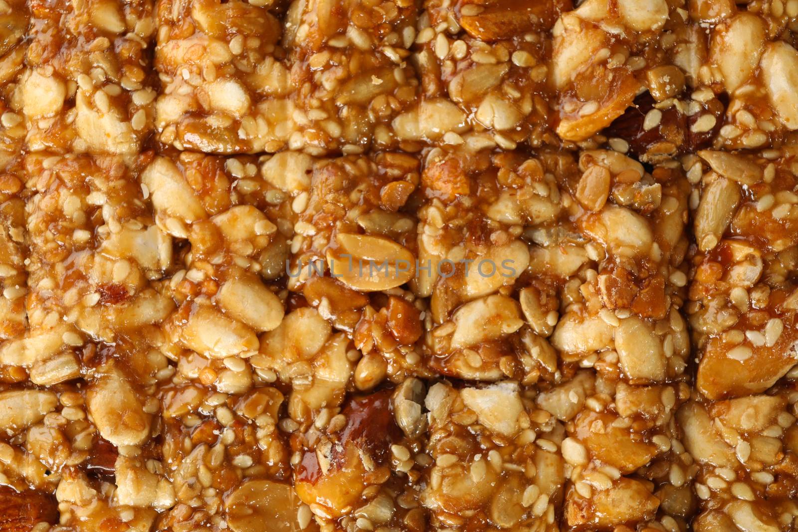 Tasty peanut brittle on whole background, close up by AtlasCompany