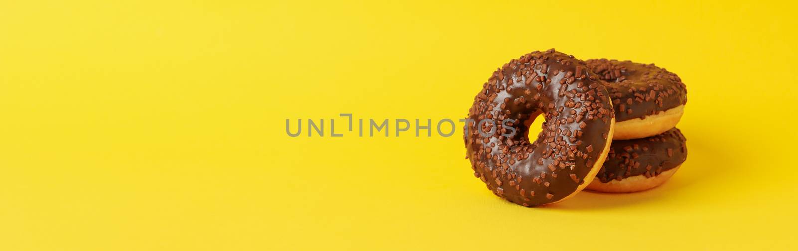 Tasty donuts on yellow background, space for text