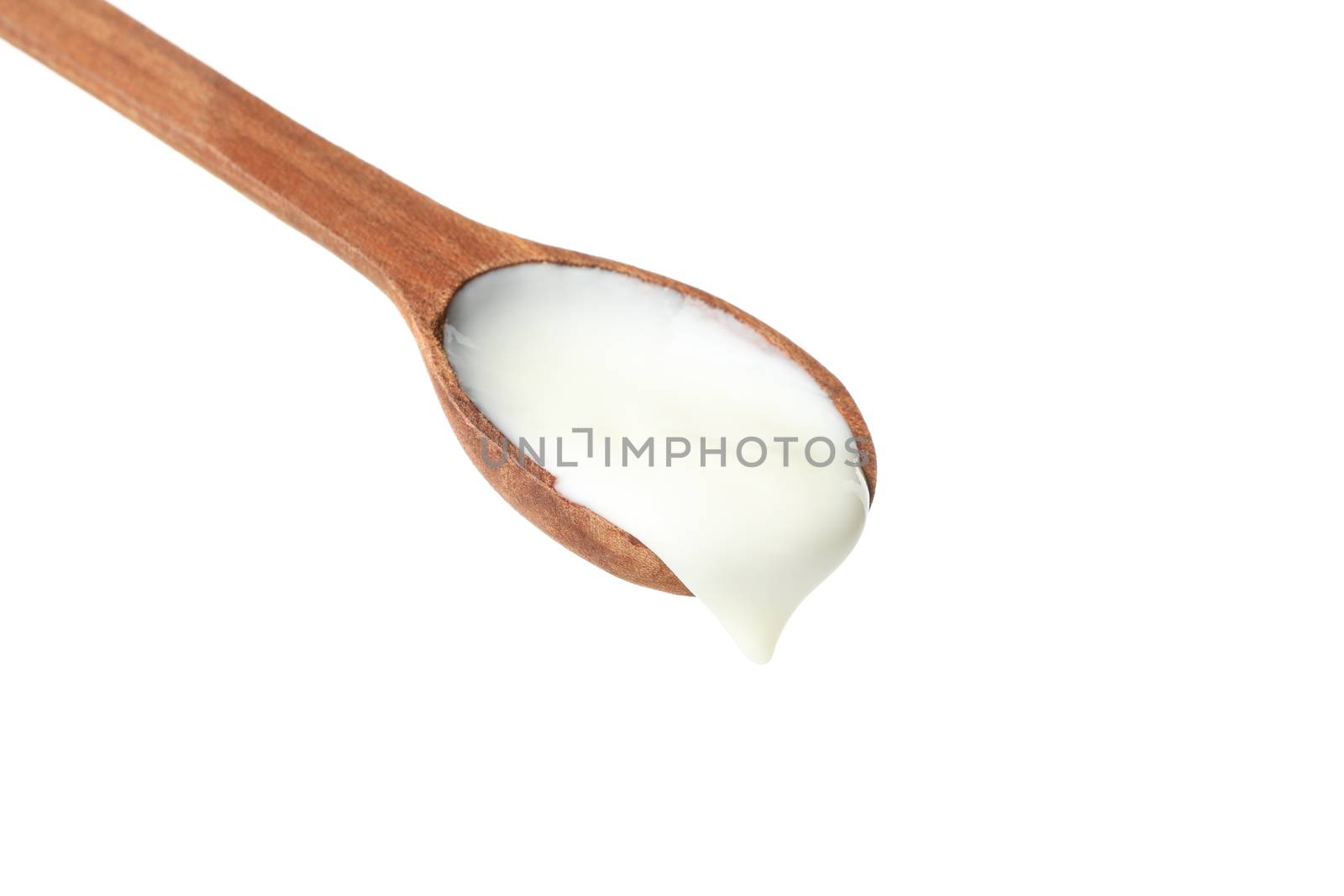 Spoon with sour cream yogurt isolated on white background