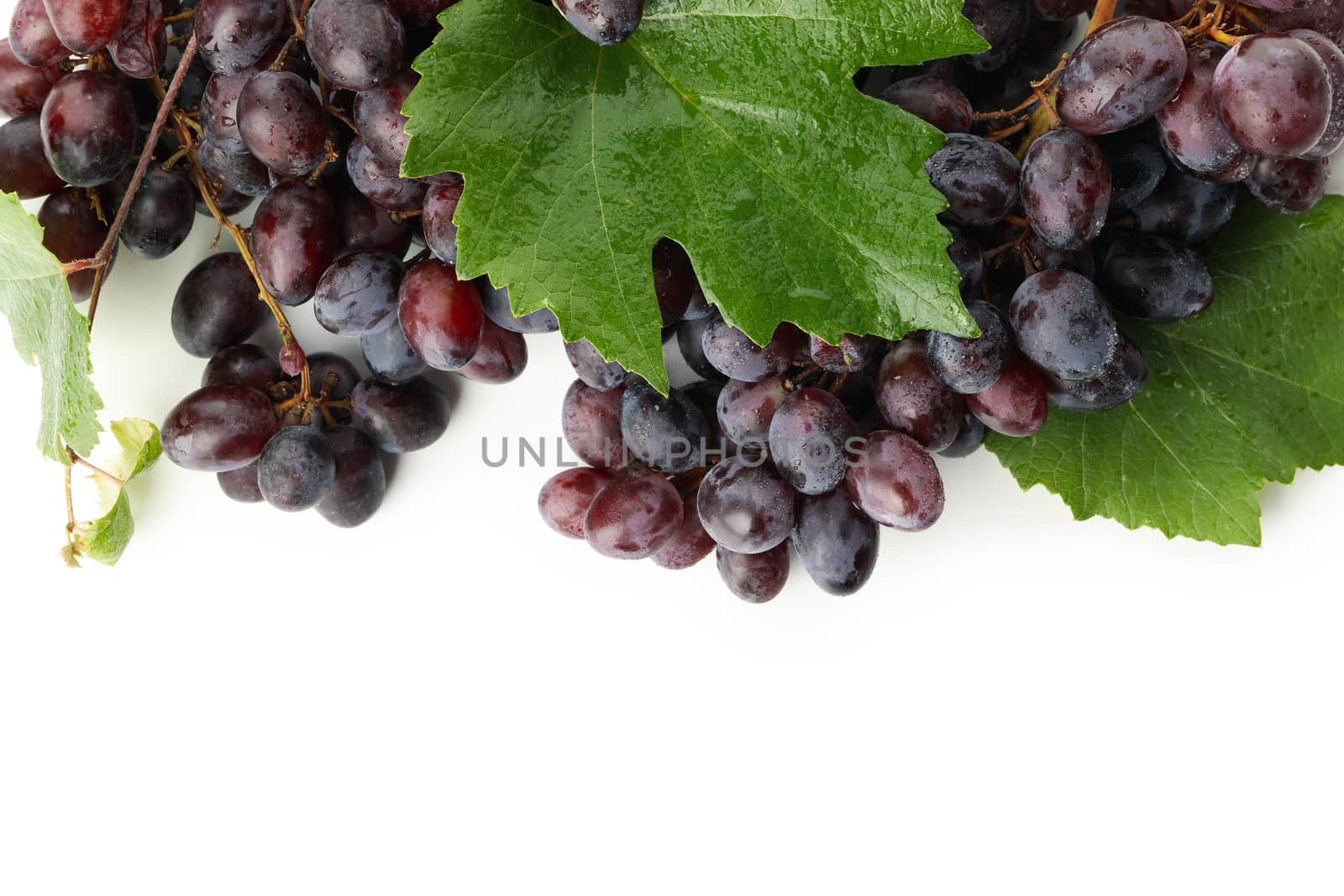 Ripe grape with leaves isolated on white background