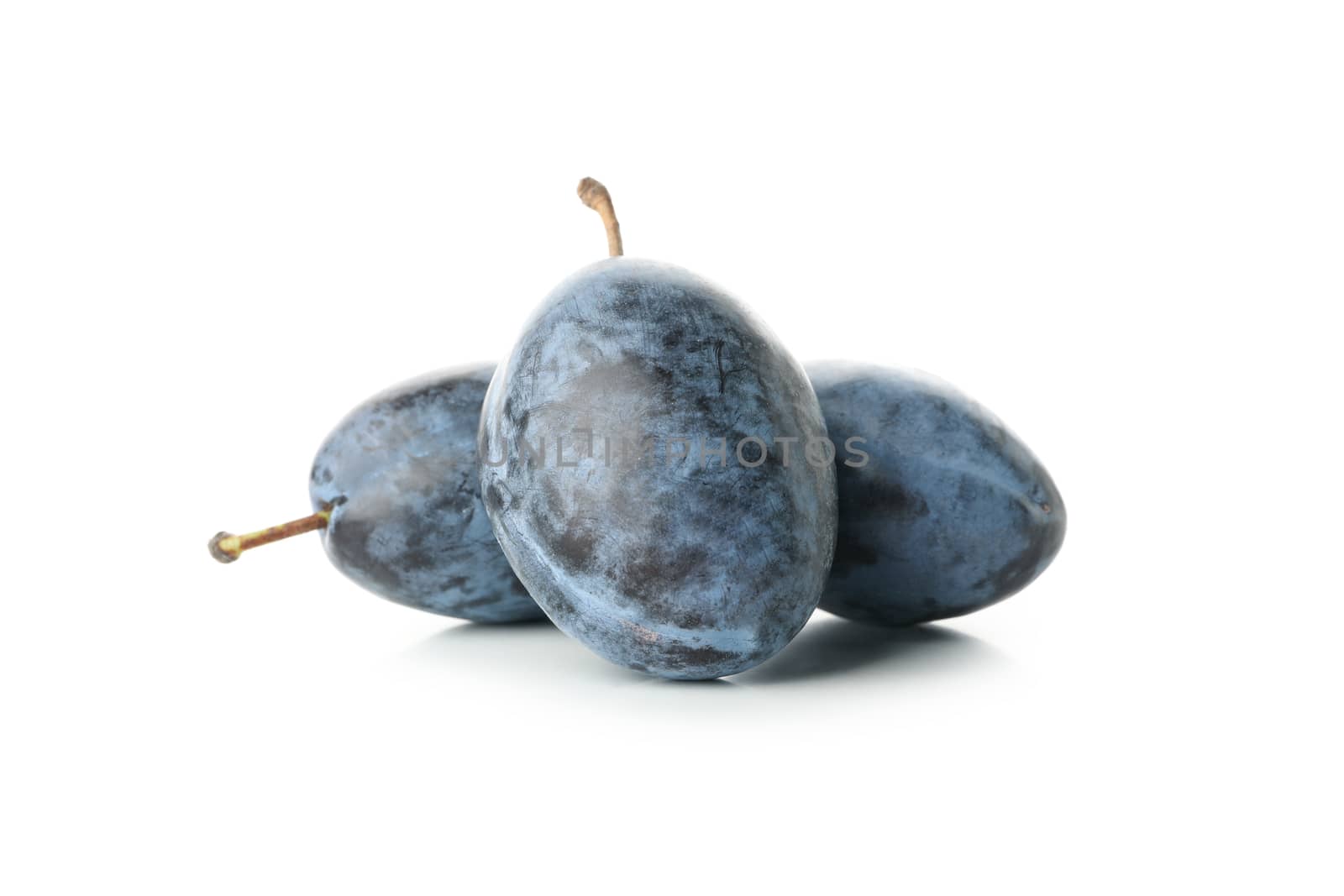 Fresh blue plums isolated on white background