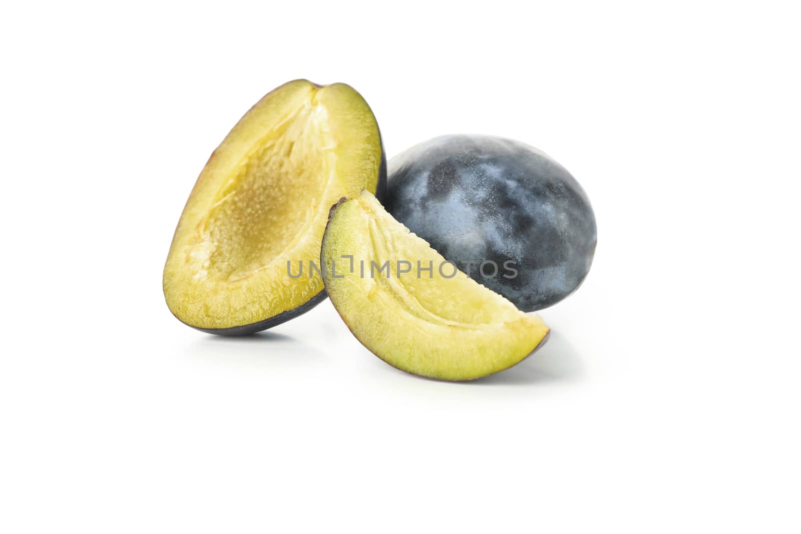 Plum and slices isolated on white background