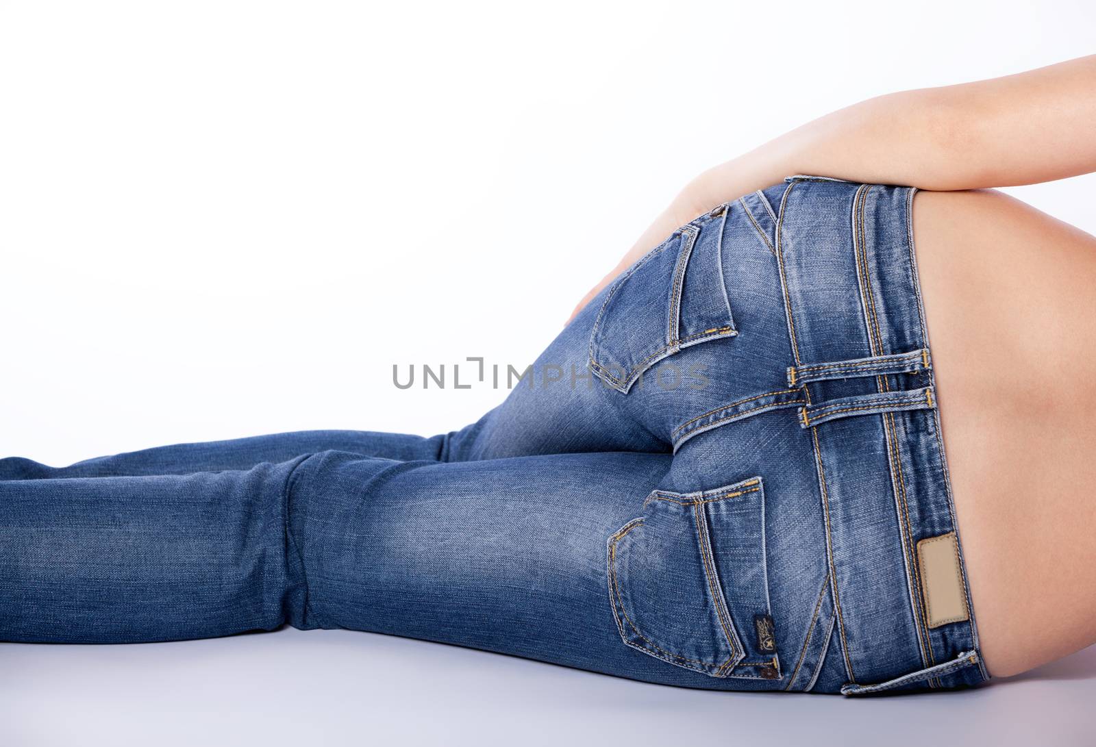 bottom of a woman in blue jeans