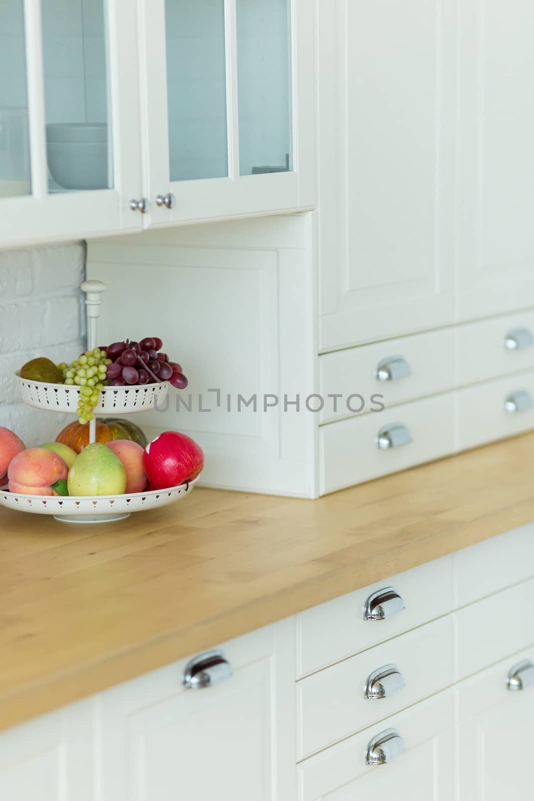 Fruit plate on the table in the modern classic white kitchen.