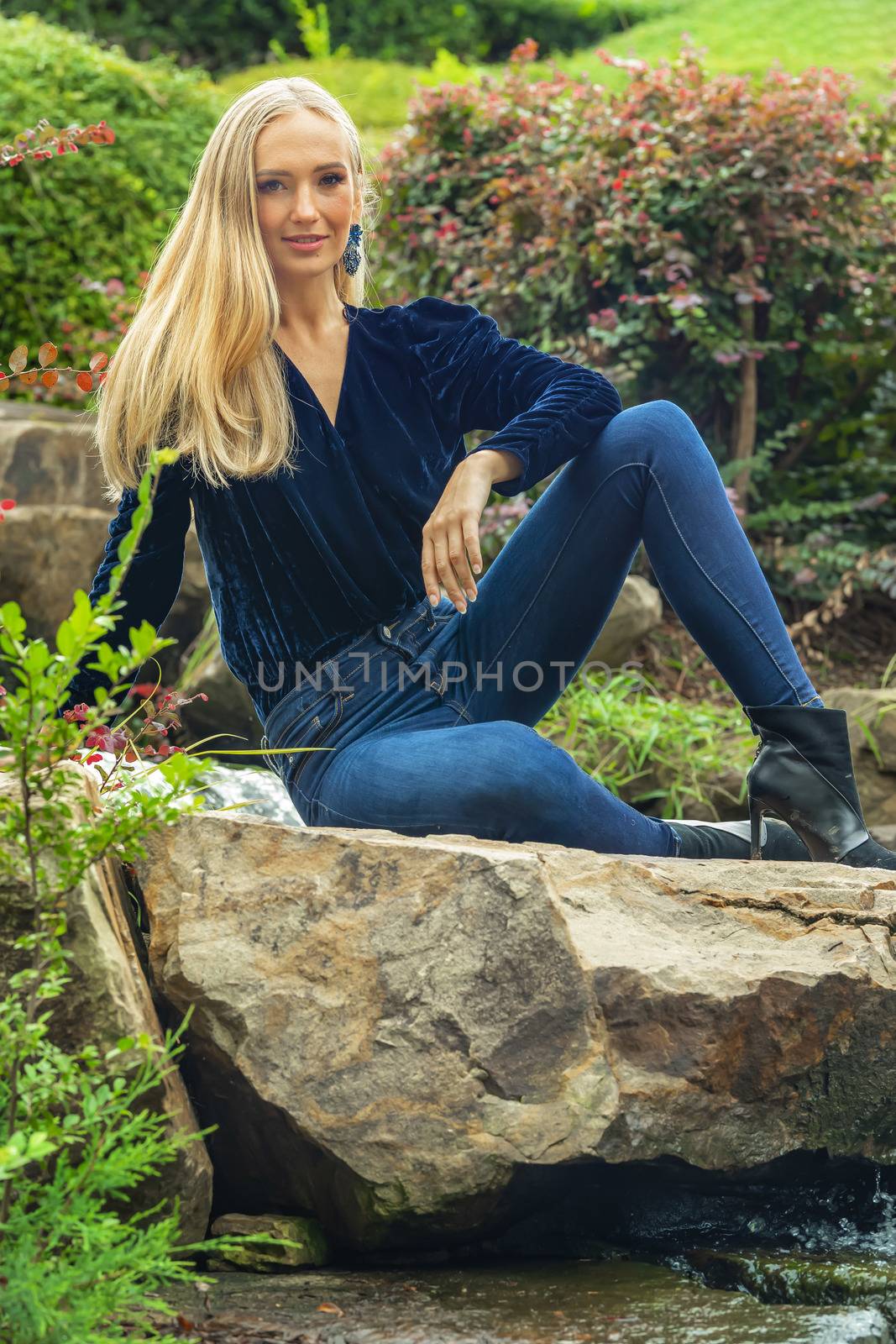 A gorgeous blonde model poses outdoors in her fall clothes