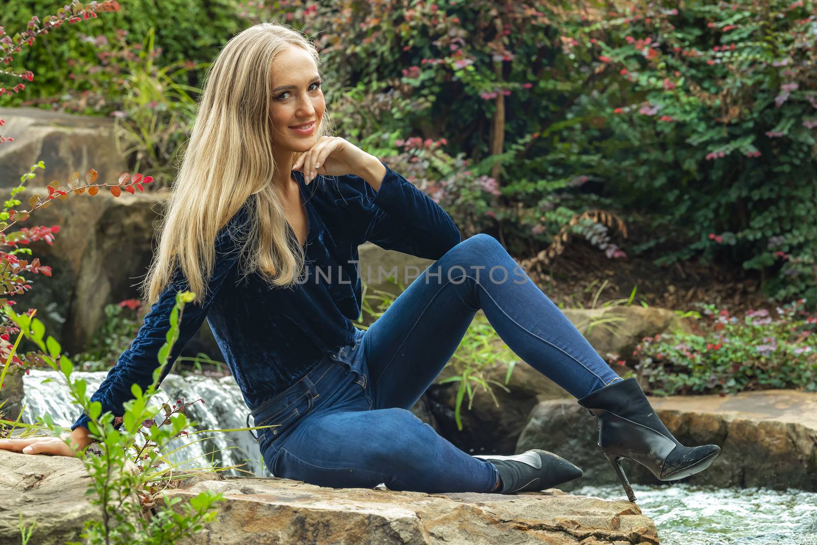 A gorgeous blonde model poses outdoors in her fall clothes