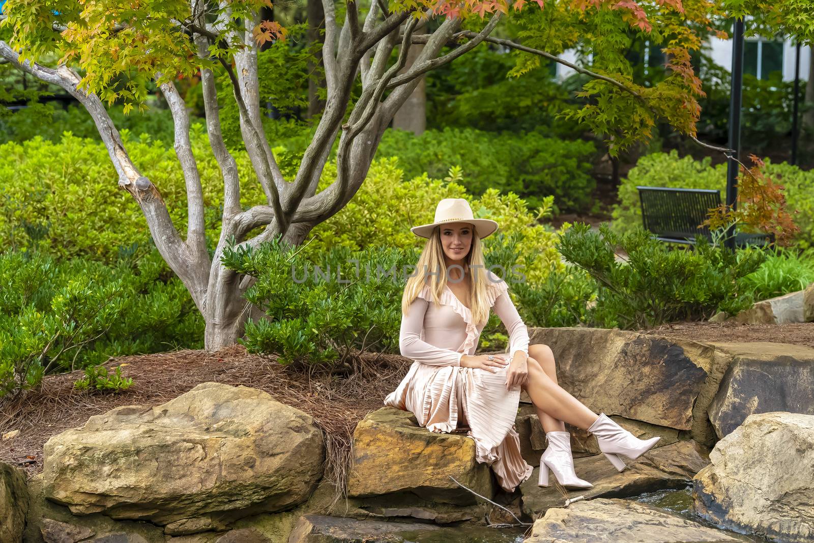 A gorgeous blonde model poses outdoors in her fall clothes