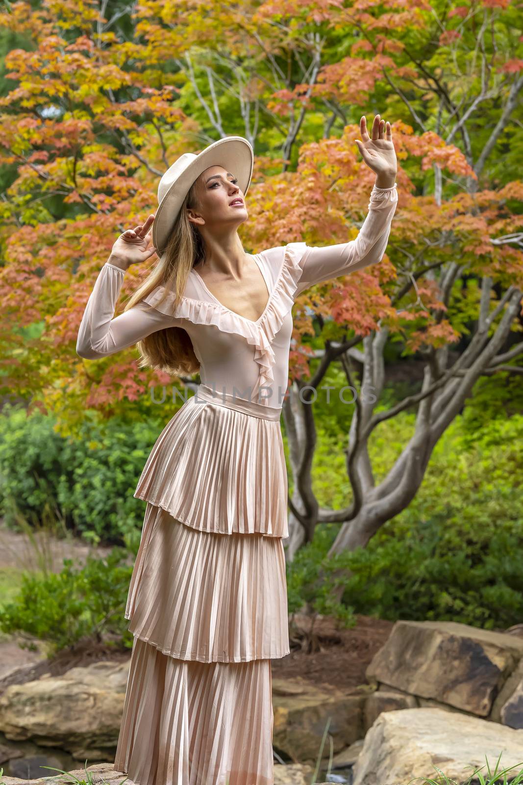 A gorgeous blonde model poses outdoors in her fall clothes