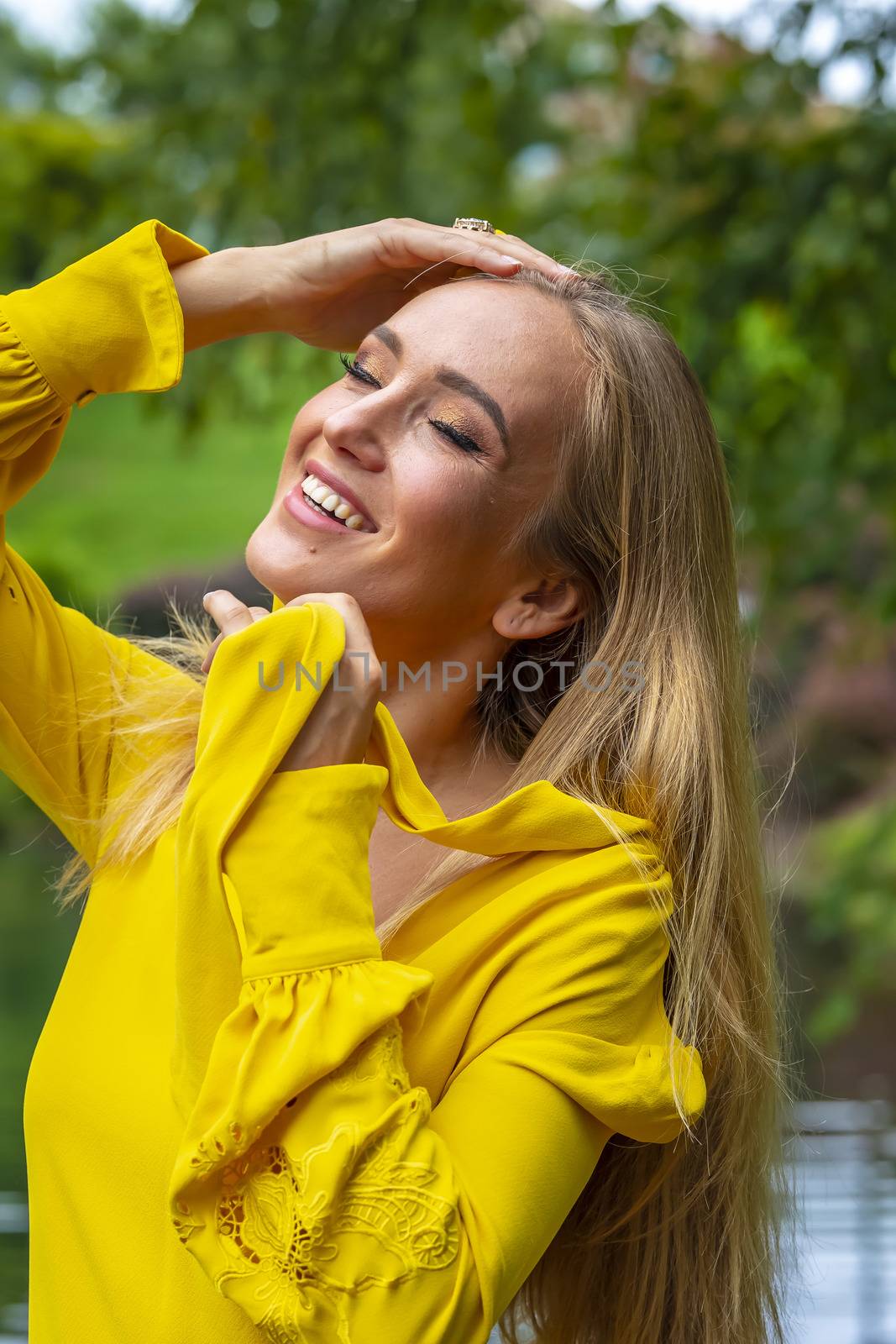 A gorgeous blonde model poses outdoors in her fall clothes