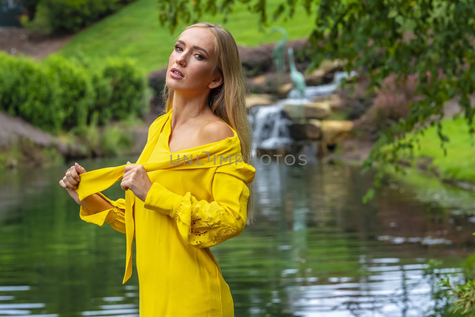 A gorgeous blonde model poses outdoors in her fall clothes