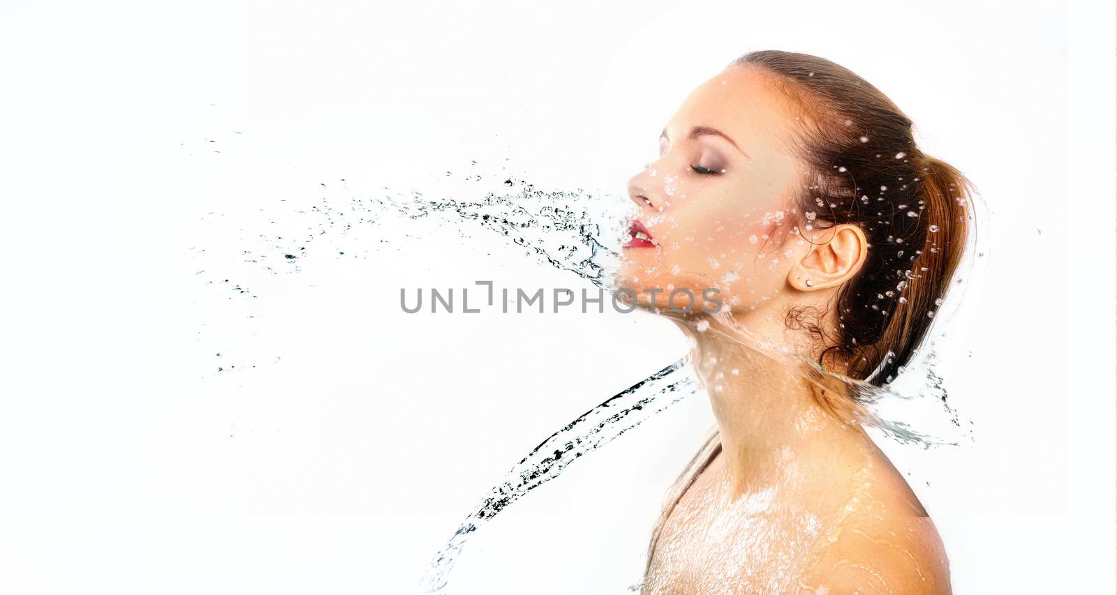 pretty woman with water splash. Beautiful model woman with a splash of water. Beautiful smiling girl underwater with fresh skin on blue background. Skin care, cleansing and moisturizing concept. Pretty face